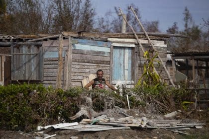 Un hombre espera entre los escombros junto a su casa afectada por el huracán Rafael, en Playa Guanimar, Artemisa (Cuba). EFE/Yander Zamora