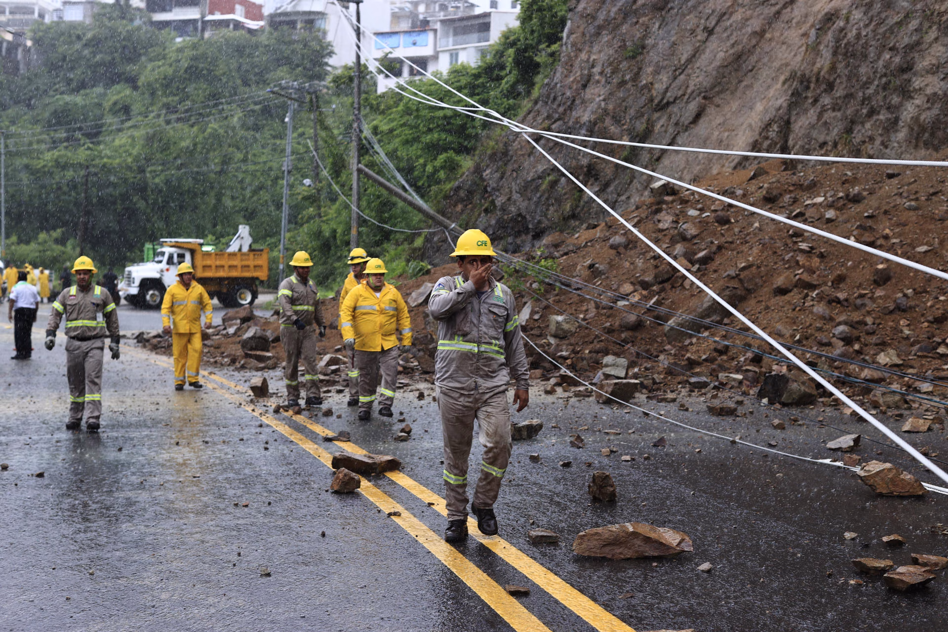 Integrantes de la Comisión Federal de Electricidad trabajan en la zona de un derrumbe provocado por las intensas lluvias en Acapulco (México). Imagen de archivo. EFE/ David Guzmán