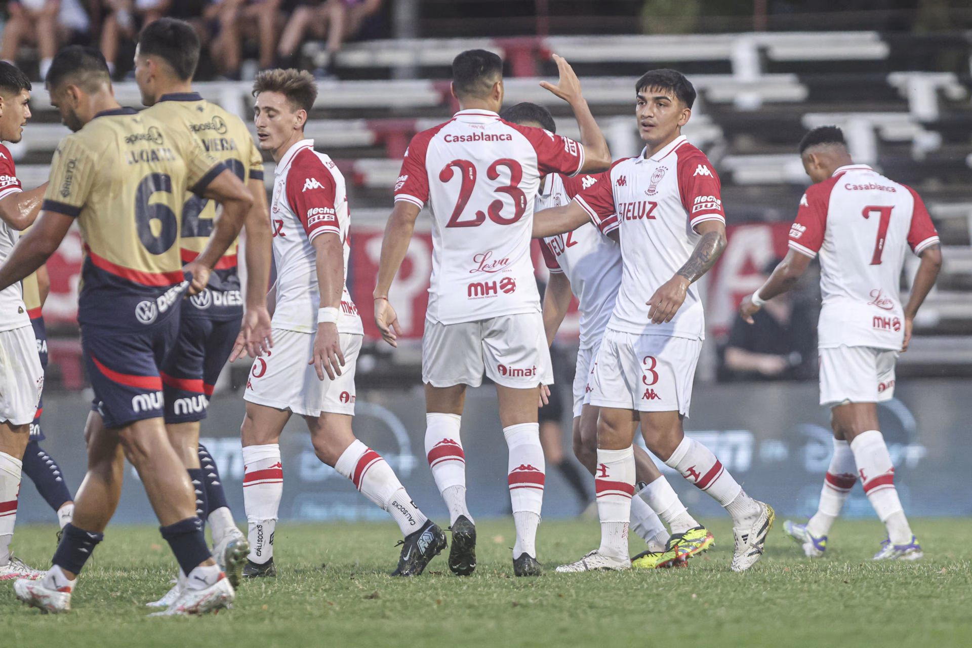 César Ibáñez (c-d) y Leonardo Sequeira (c) de Huracán celebran un gol este martes en un partido amistoso entre Huracán y Cerro Porteño en el Estadio Parque Federico Saroldi, en Montevideo (Uruguay). EFE/ Gastón Britos